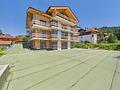 Exklusive Neubauwohnung mit traumhaftem Süd- & Westpanoramabalkon am Schliersee - Hausansicht vom Garten / Stand 07.26